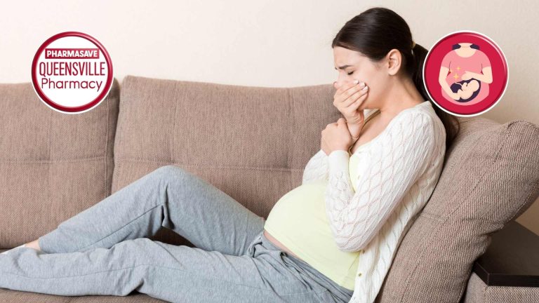 Pregnant woman on couch holding mouth, trying not to vomit.